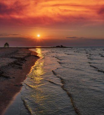 Dramatic sunset sky over Baltic sea in summer evening. Empty landscape, seacoast, clouds and sea.