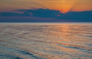 Dramatic sunset sky over Baltic sea in summer evening. Empty landscape, seacoast, clouds and sea.
