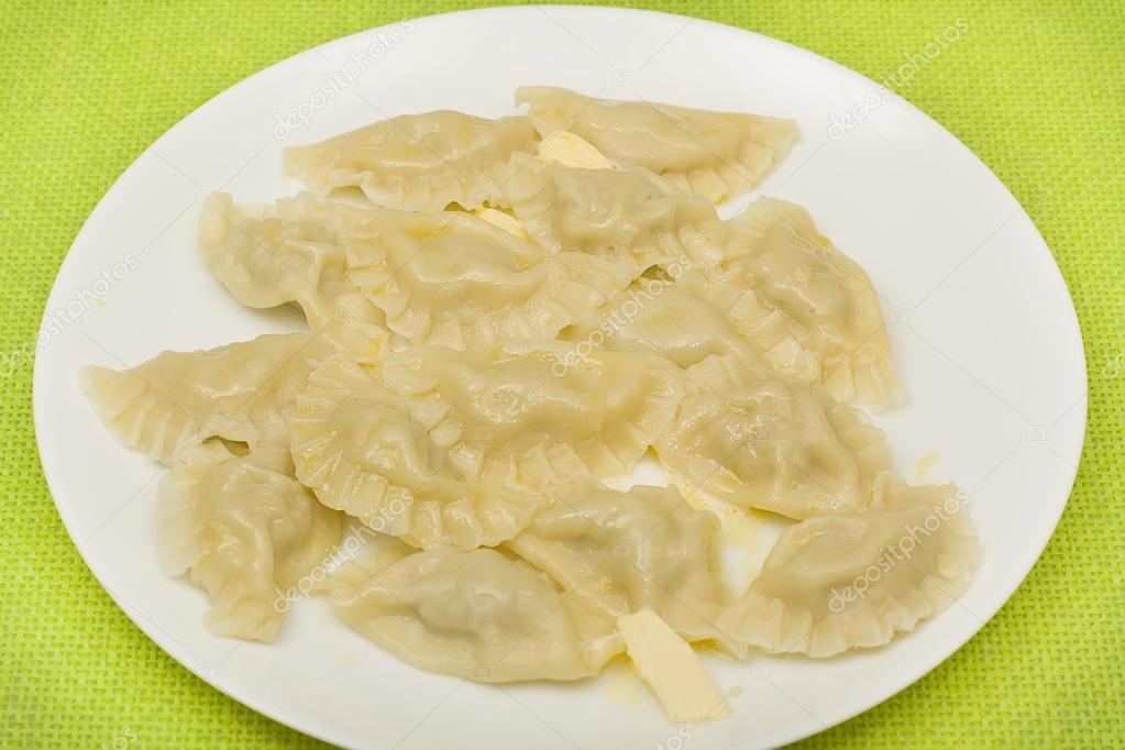 Boiled dumplings with butter Stock Photo by ©SergeyKolesnikov 16869585