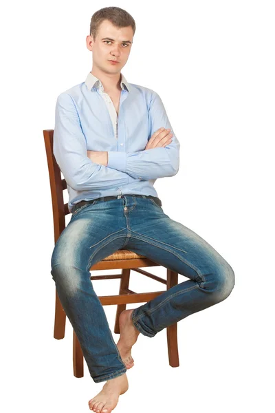 Chlapík sedí na židli — Stock fotografie