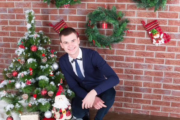 Giovane ragazzo accanto a un albero di Natale — Zdjęcie stockowe