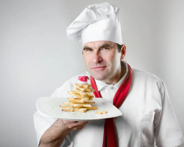 Chef showing plate with Christmas tree — Stock Photo, Image