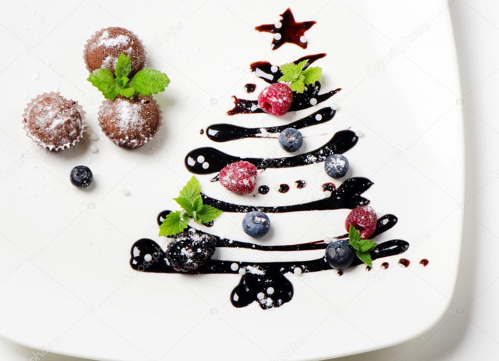 Cupcakes and sweet christmas tree with berries
