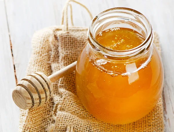 Glass jar of honey — Stock Photo, Image