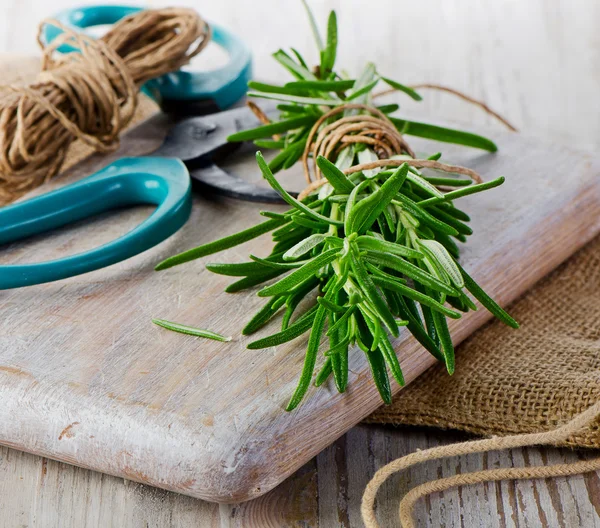 Rosemary on wooden table — Stock Photo, Image
