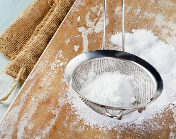 Powdered sugar in a metal sieve — Stock Photo, Image