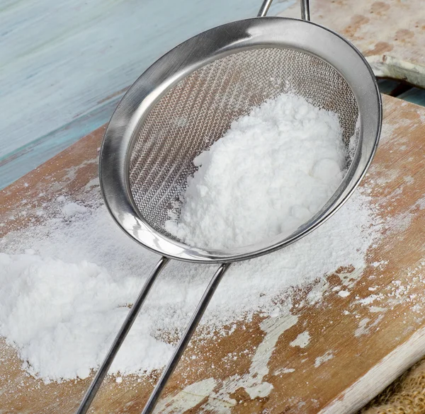 Powdered sugar in a metal sieve — Stock Photo, Image