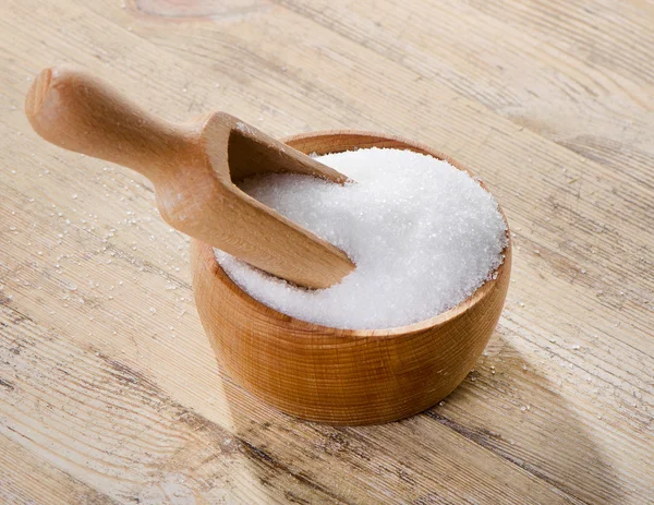 Sugar on wooden table — Stock Photo, Image