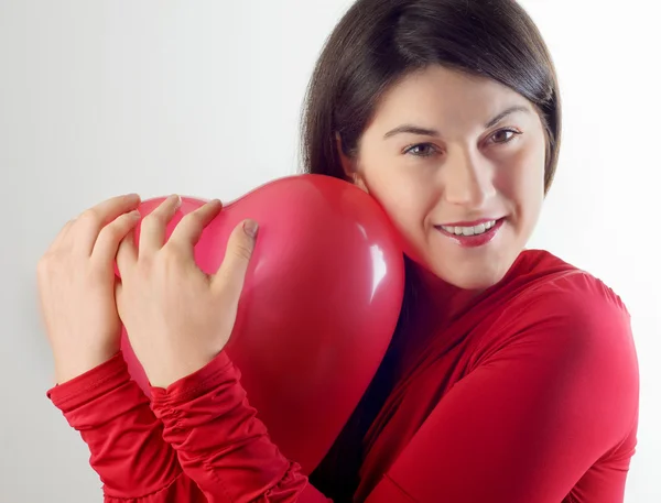 Woman holding red heart shaped balloon — Stock Photo, Image