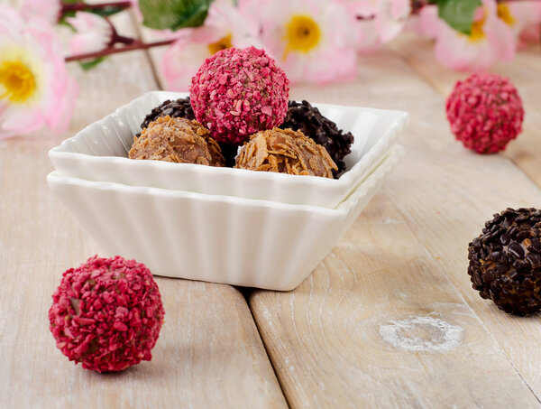 Chocolates on wooden table.