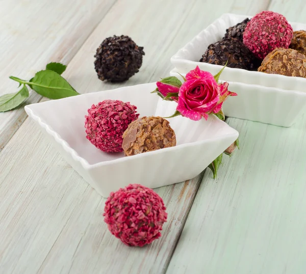 Chocolates on wooden table. — Stock Photo, Image