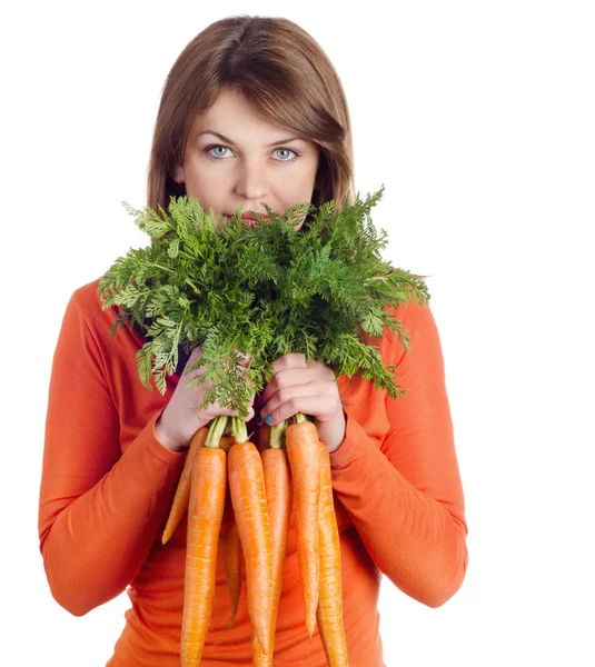 Woman holds bunch of carrots — Stock Photo, Image