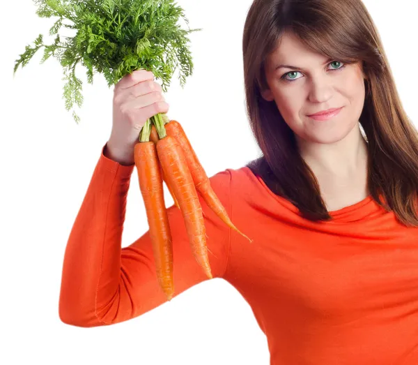 Woman holds bunch of carrots Royalty Free Stock Photos