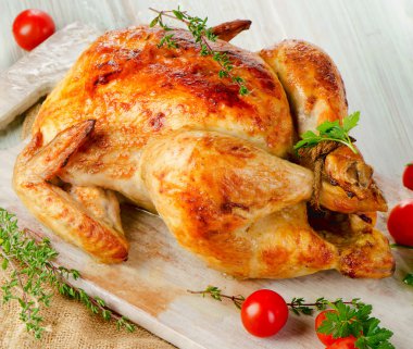 Roasted chicken on wooden table clipart