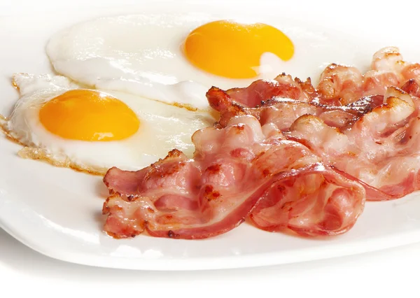 Traditional breakfast with bacon and fried eggs Royalty Free Stock Images