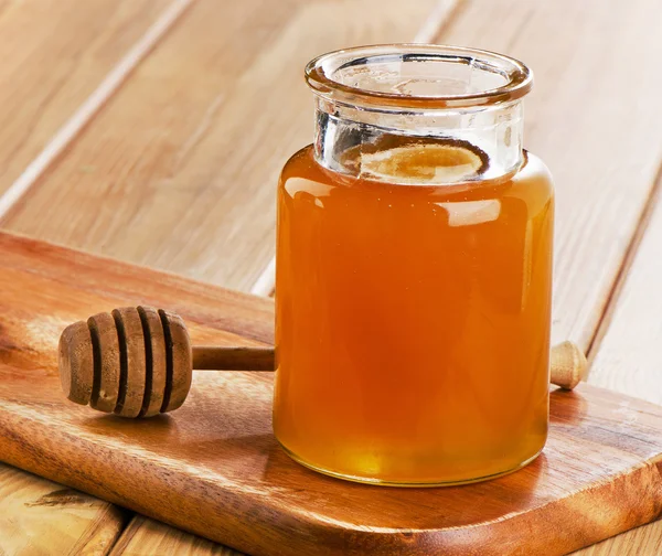 Glas krukke af honning - Stock-foto