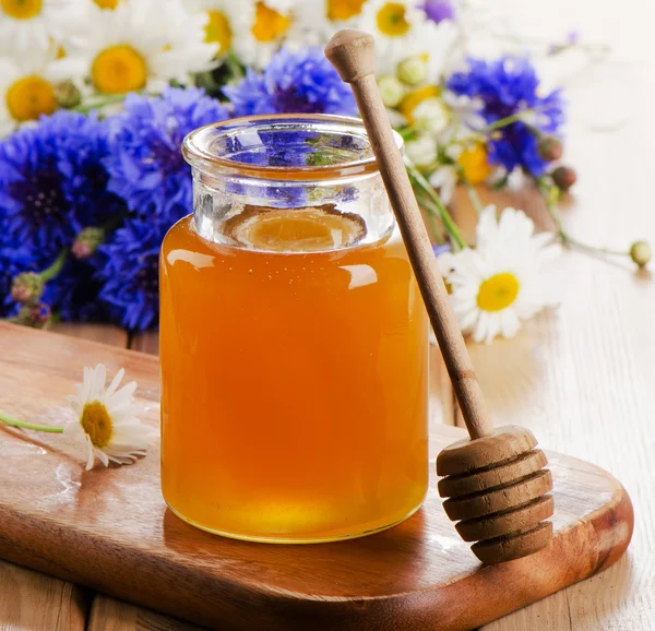 Honey Jar with wooden stick — Stock Photo, Image