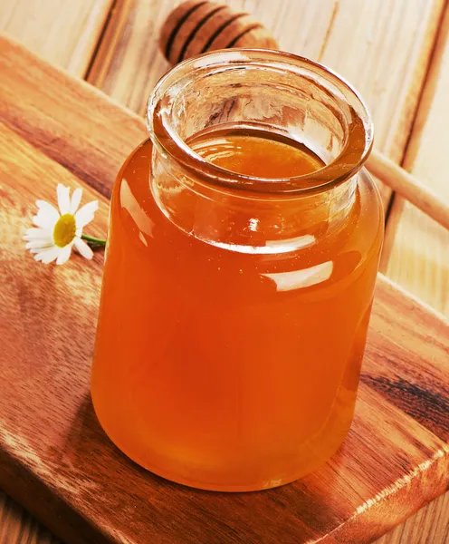 Glas krukke af honning - Stock-foto