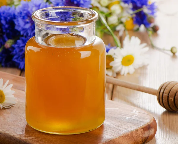 Honey Jar with wooden stick — Stock Photo, Image