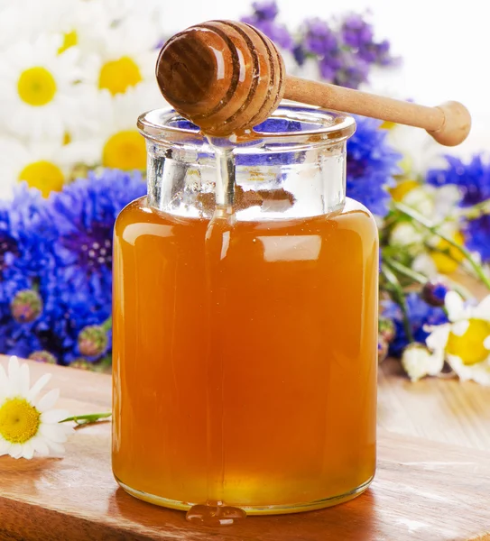 Honey Jar with wooden stick — Stock Photo, Image