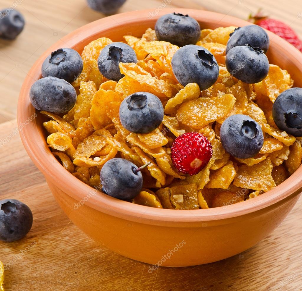 Corn flakes with blueberries — Stock Photo © bit245 50007049