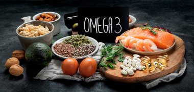 Assortment of omega 3 best sources on dark background. Healthy diet concept.  clipart