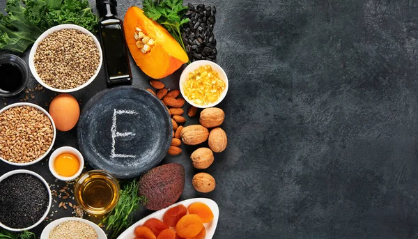 暗い背景にビタミンEが高い食品 健康的な食事の概念 トップビュー フラットレイアウト コピースペース — ストック写真