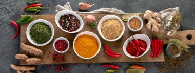 Gri arka planda çeşitli baharatlar. Geleneksel baharat konsepti. Üst manzara, düz yatış, manzara