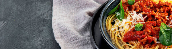 Spaghetti Bolognese on gray background. Traditional Italian pasta. Homemade food concept. panorama, copy space