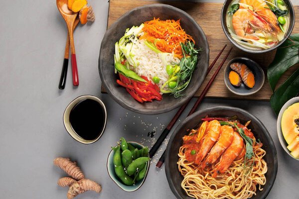 Asian dishes variety on gray background. Traditional food cocnept. Top view, flat lay, copy space
