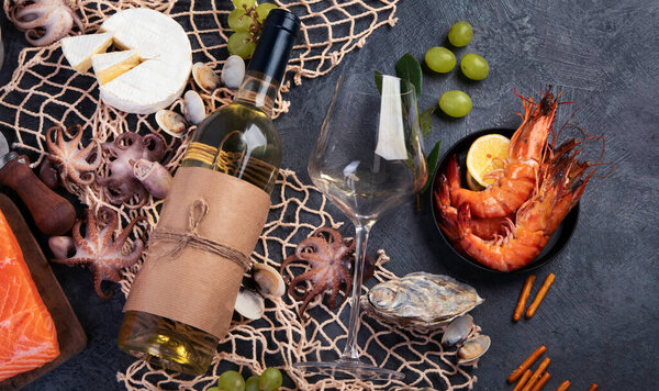 White wine Chardonay with seafood and snacks. Traditional alcohol drinks. Top view, flat lay, copy space