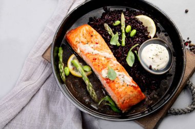 Kuşkonmaz ve siyah pirinçle pişirilmiş somon. Akdeniz diyeti konsepti. Düz konum, üst görünüm, kopyalama alanı