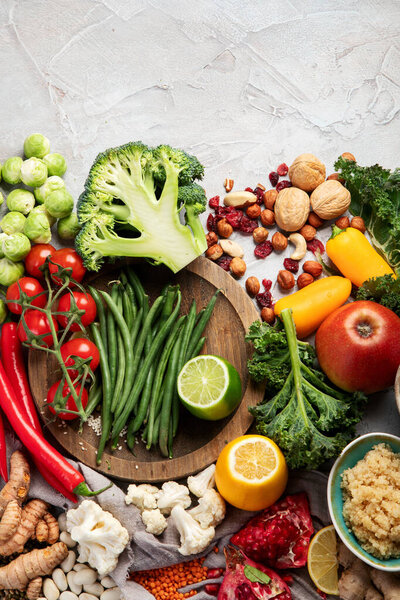 Plant based diet on gray background. Healthy food concept. Top view, flat lay, copy space