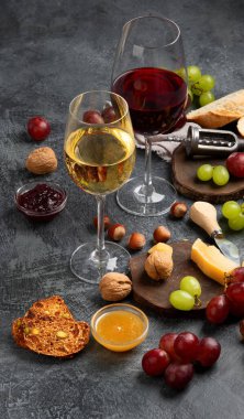 Gri arka planda aperatifleri olan kırmızı şarap. Parti için yaz içeceği, şarap dükkanı ya da şarap tatma konsepti. 