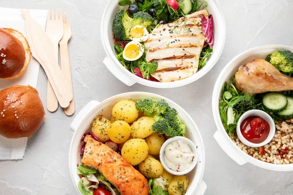 Healthy meal prep in lunch boxes on light background. Dieting eating concept. Flat lay, top view