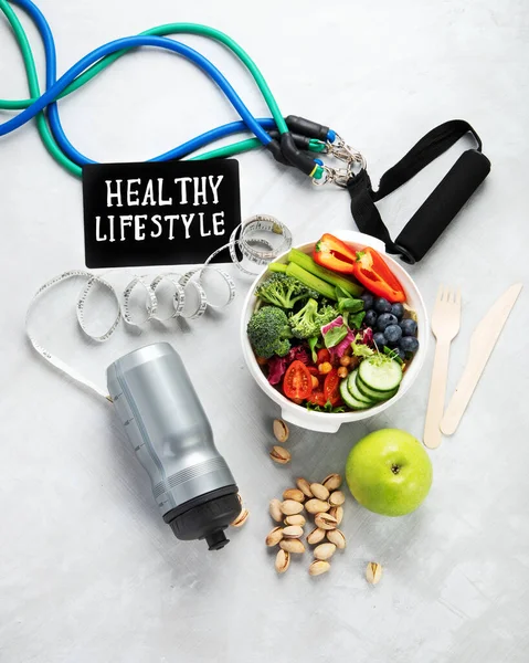 Healthy food and exercising equipment. Concept of healthy lifestyle. Flat lay, top view, copy space