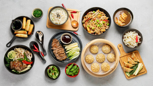 Assorted Chinese food set on light background. Traditional food concept. Asian style banquet. Top view, flat lay, copy space