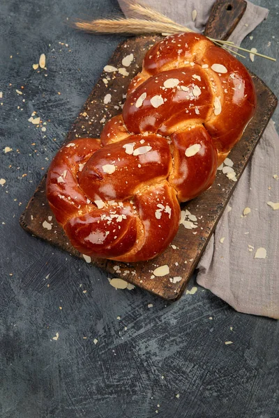 Easter sweet bread, tsoureki cozonac on dark background. Easter time, springtime. Top view, flat lay, copy space