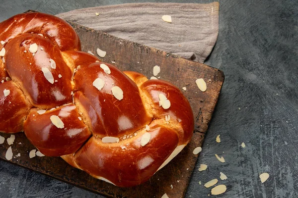 Easter sweet bread, tsoureki cozonac on dark background. Easter time, springtime. Top view, flat lay, copy space