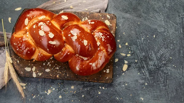 Easter sweet bread, tsoureki cozonac on dark background. Easter time, springtime. Top view, flat lay, copy space