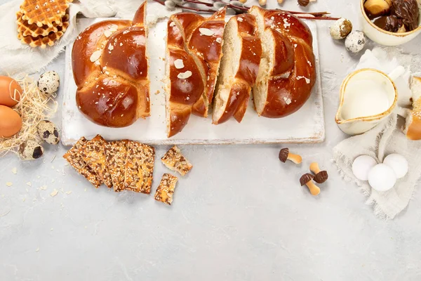 Easter sweet bread, tsoureki cozonac sliced. Easter time, springtime. Holiday food concept. Top view, flat lay, copy space