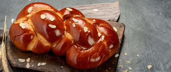 Easter sweet bread, tsoureki cozonac on dark background. Easter time, springtime. copy space