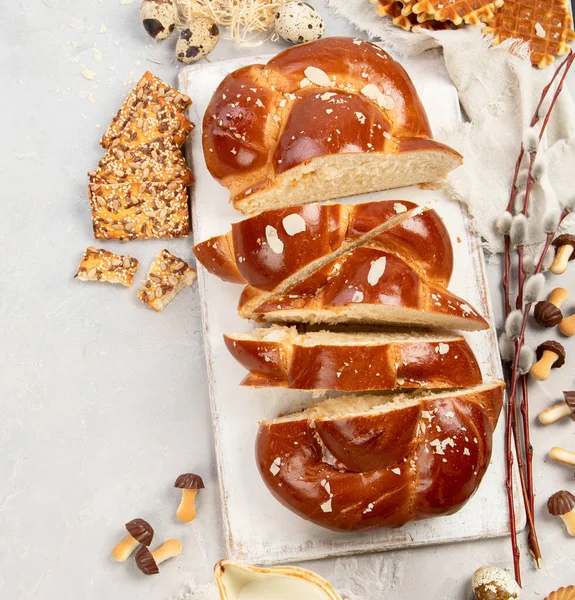 Easter sweet bread, tsoureki cozonac sliced. Easter time, springtime. Holiday food concept. Top view, flat lay, copy space