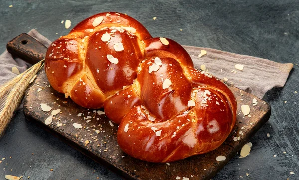 Easter sweet bread, tsoureki cozonac on dark background. Easter time, springtime. panorama, copy space