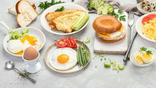 Various ways of cooking chicken eggs on light background. Breakfast food concept.