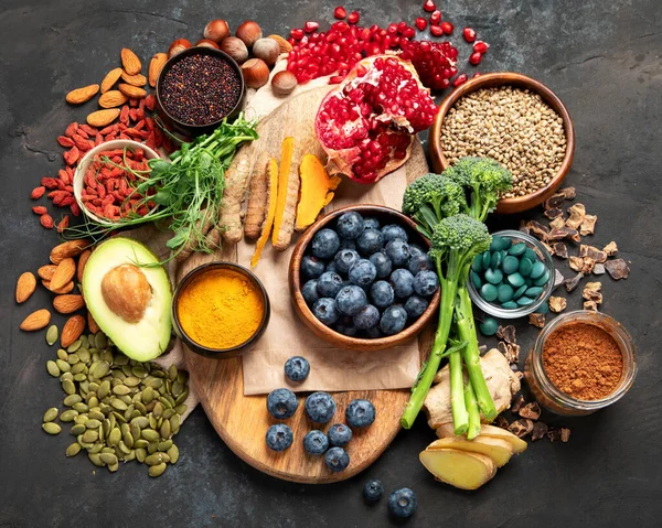 Sağlıklı yiyecekler, temiz yemek seçimleri, karanlık arka planda. Dengeli diyet konsepti. Süper yemek çeşitleri. Üst manzara, düz uzanma