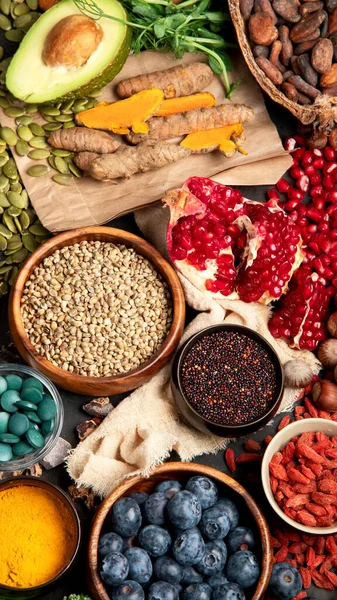 Sağlıklı yiyecekler, temiz yemek seçimleri, karanlık arka planda. Dengeli diyet konsepti. Süper yemek çeşitleri. Üst manzara, düz uzanma