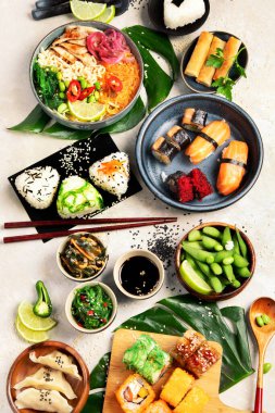 Japanese food assortment on light background. Traditional food concept. Dishes and appetizers of indeed cuisine. Top view, flat lay