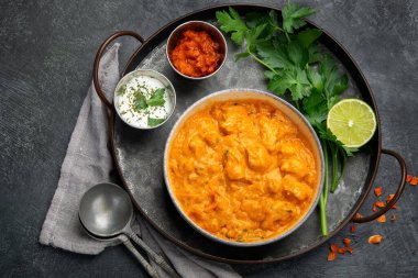 Indian curry on dark backgroound. Traditional food concept. Dishes and appetizers of indeed cuisine. Copy space, top view, flat view
