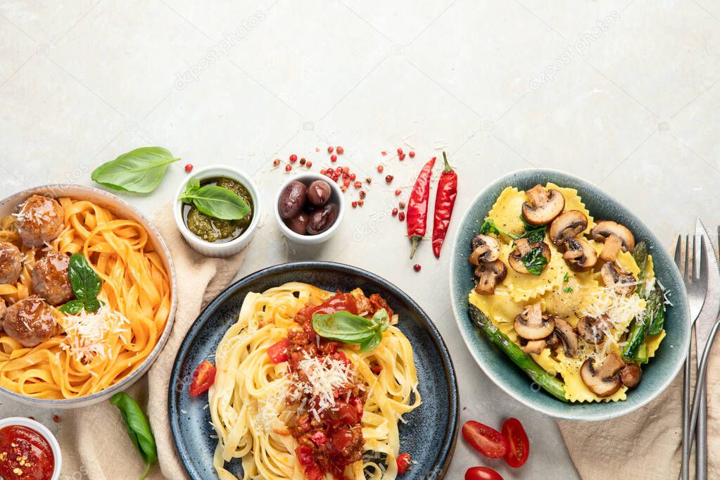 Italian pasta assortment on light background. Traditional food concept. FLat lay, Top view, copy space